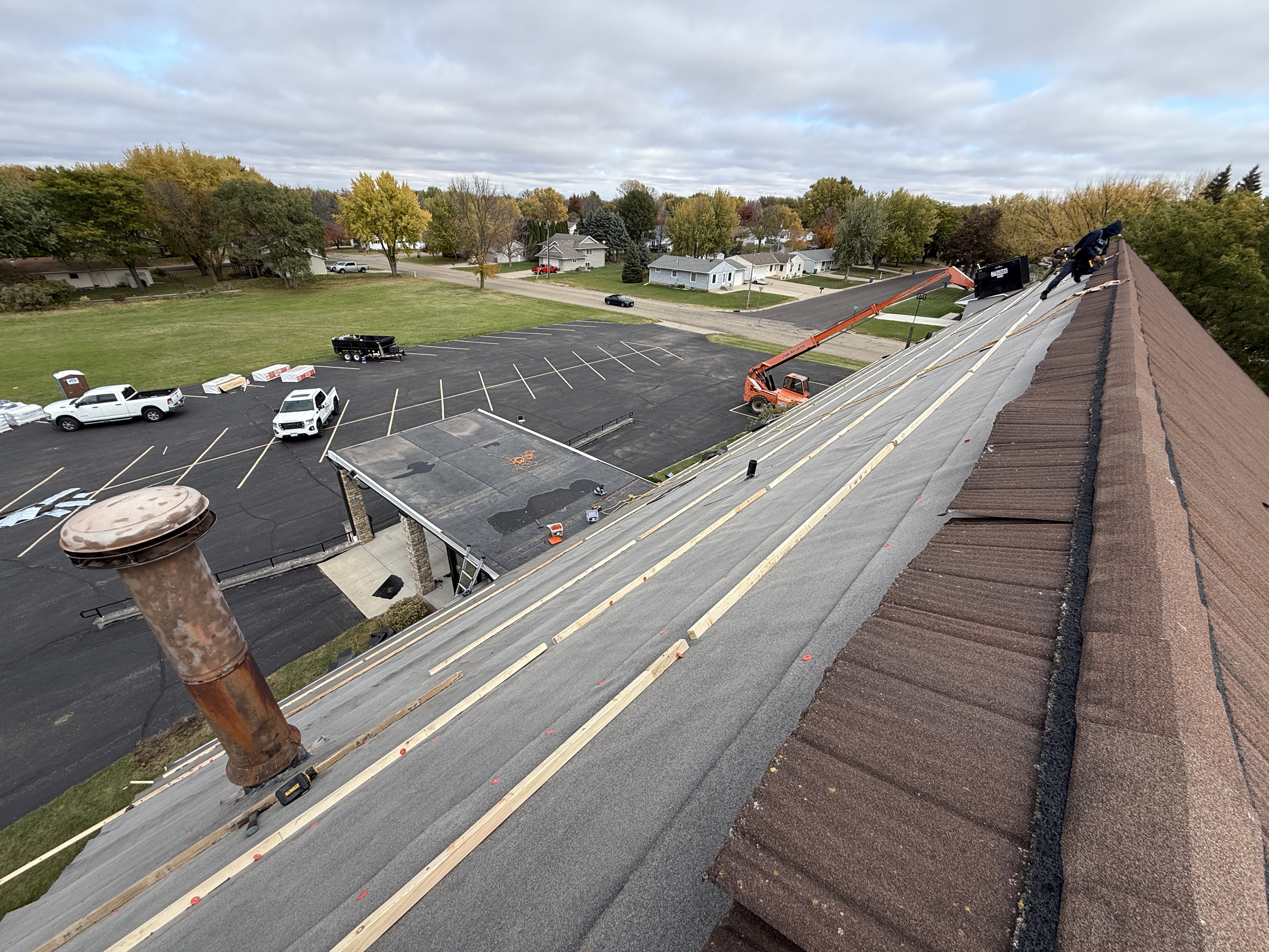 Commercial metal roof installation along a long ridge