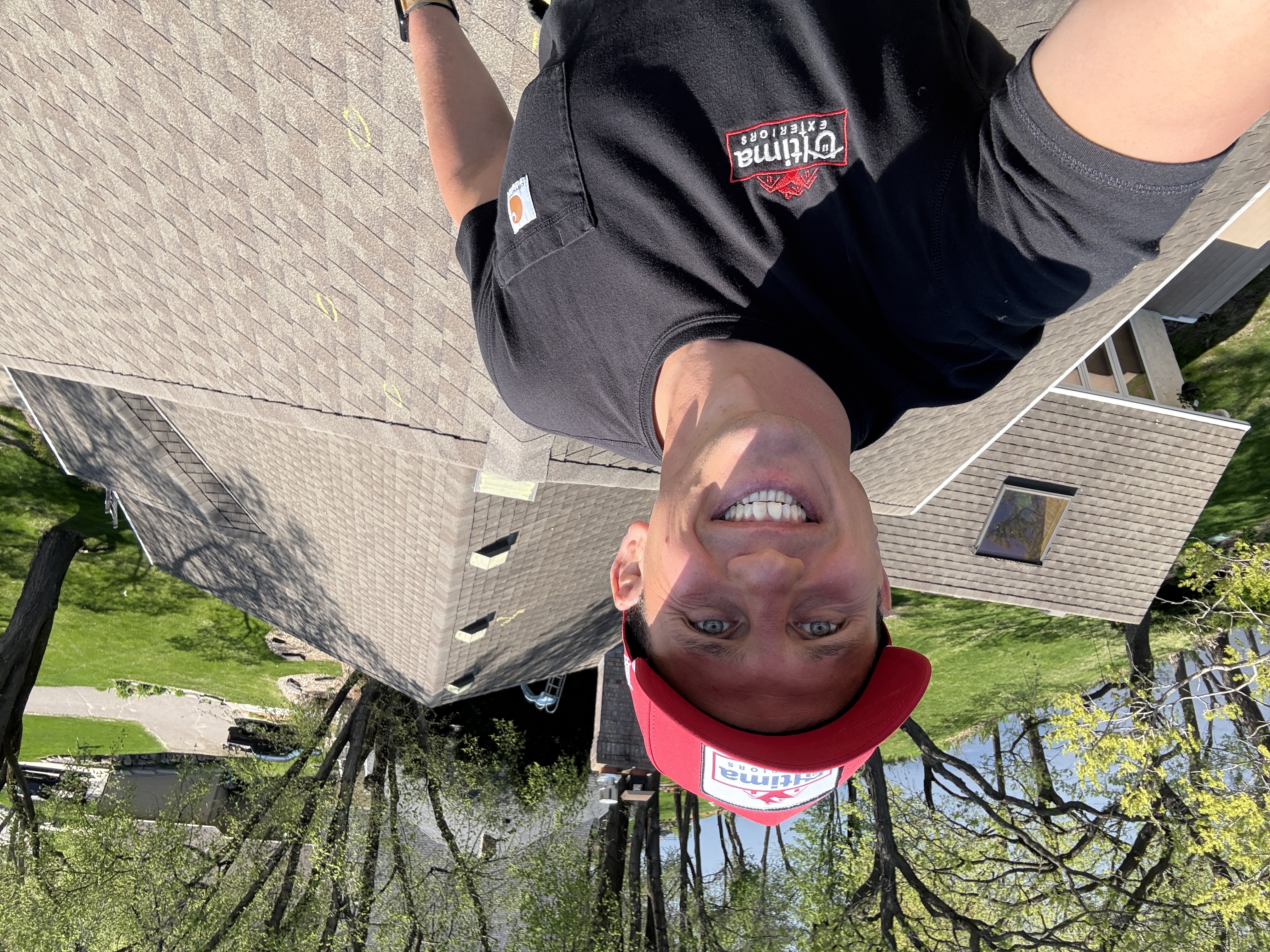 Ultima Exteriors crew member on a roof