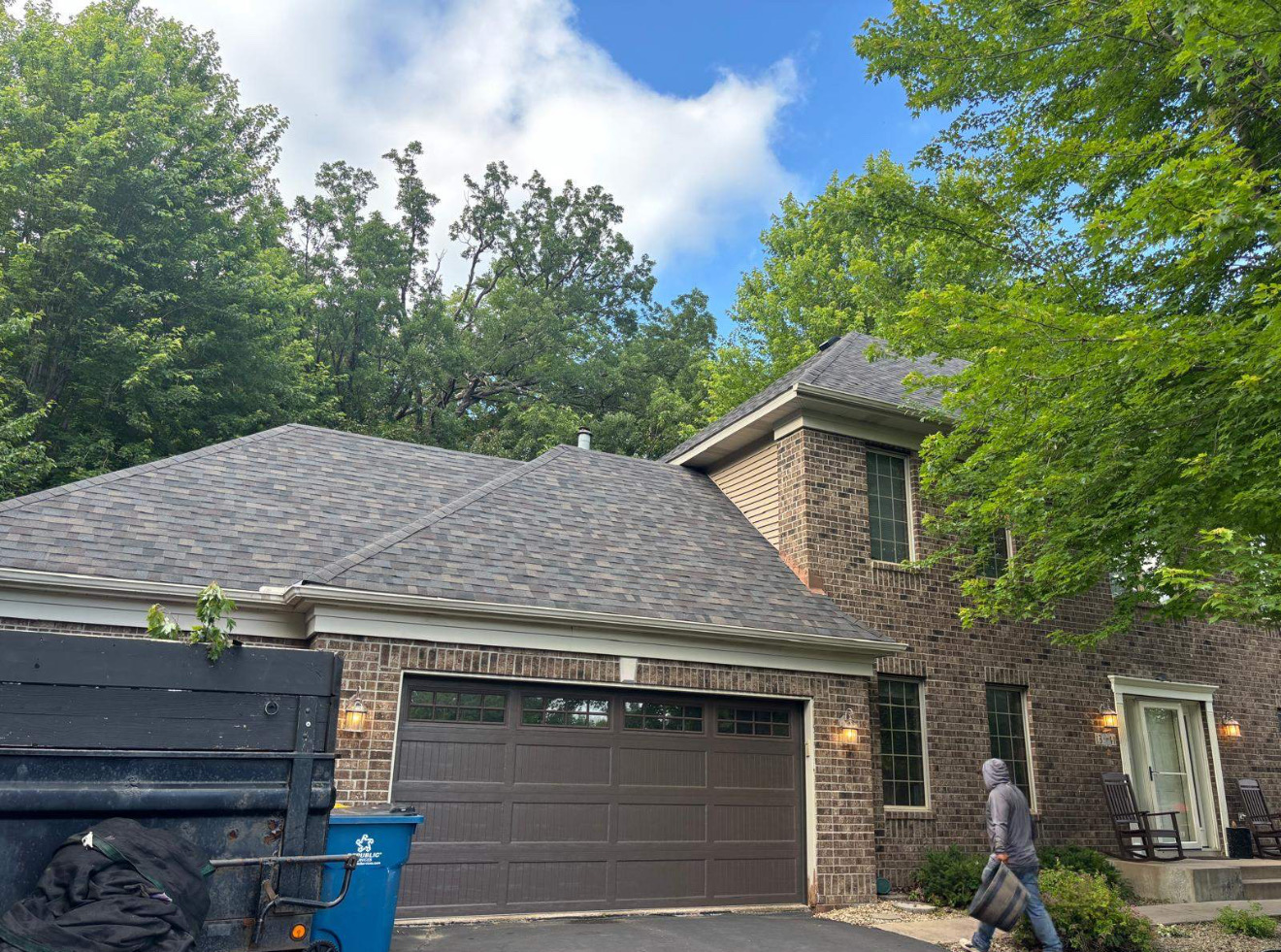 Two-story home with stone accents and a new gray roof
