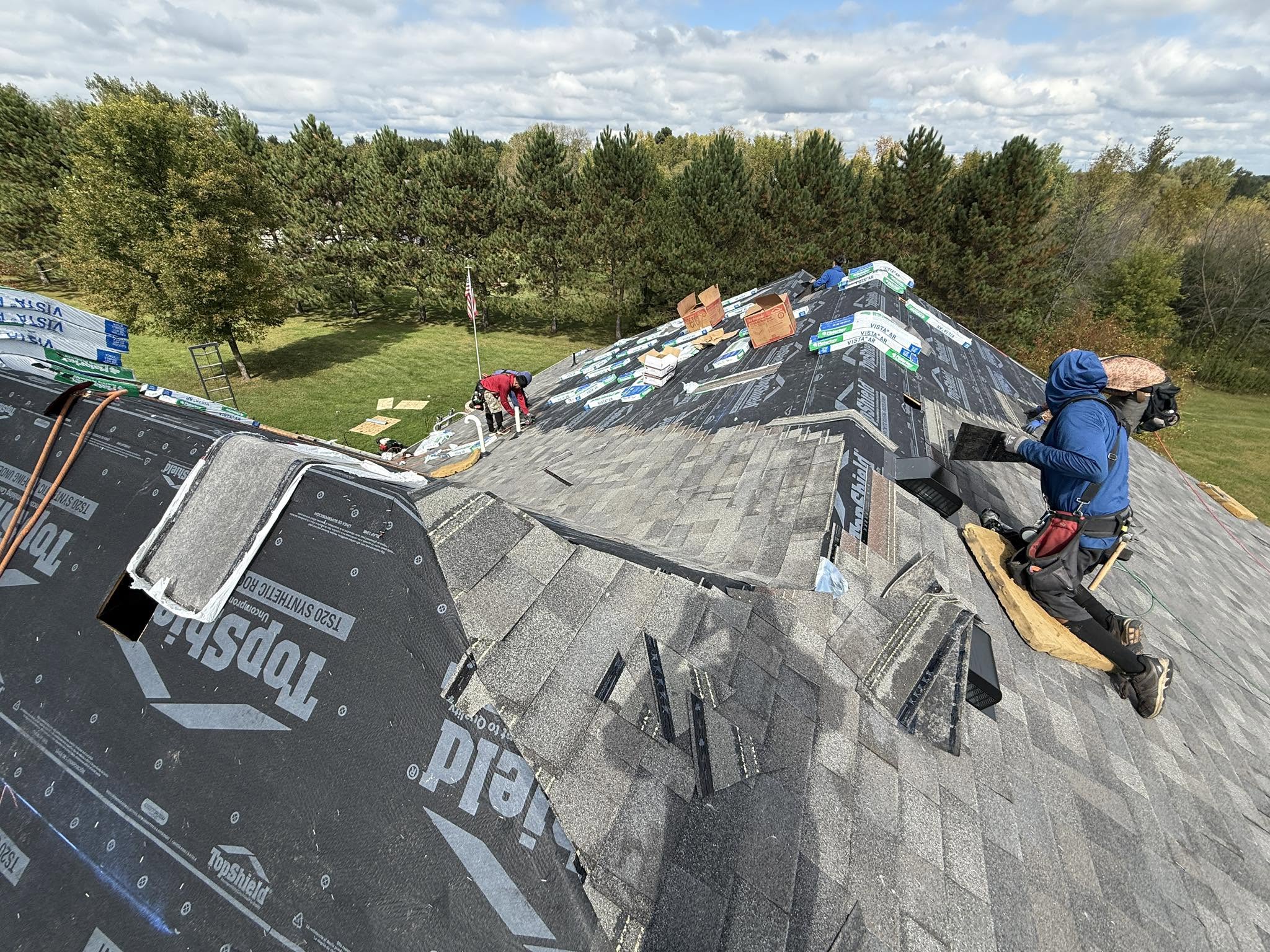 Ultima Exteriors crew repairing a roof
