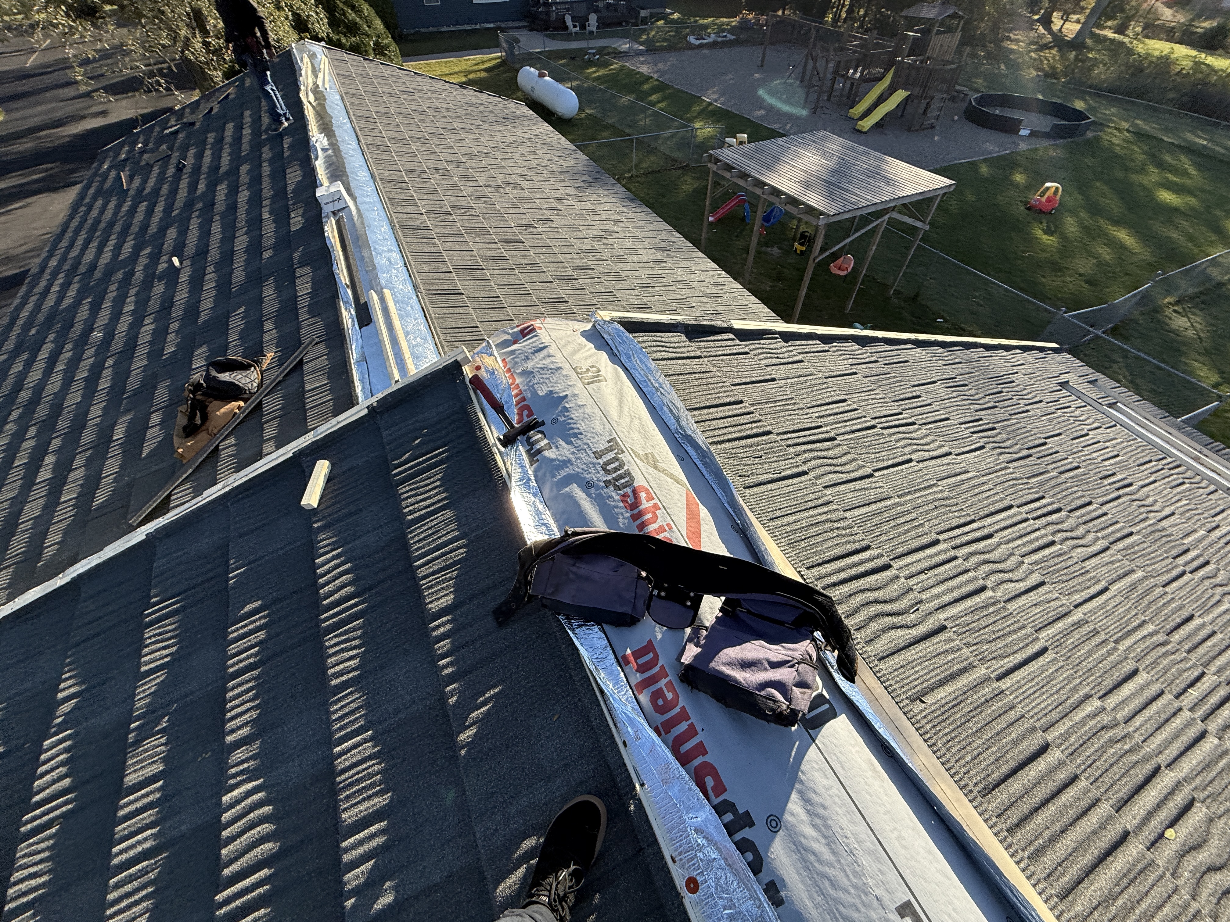 Gray shingle roof with multiple valleys and dormers