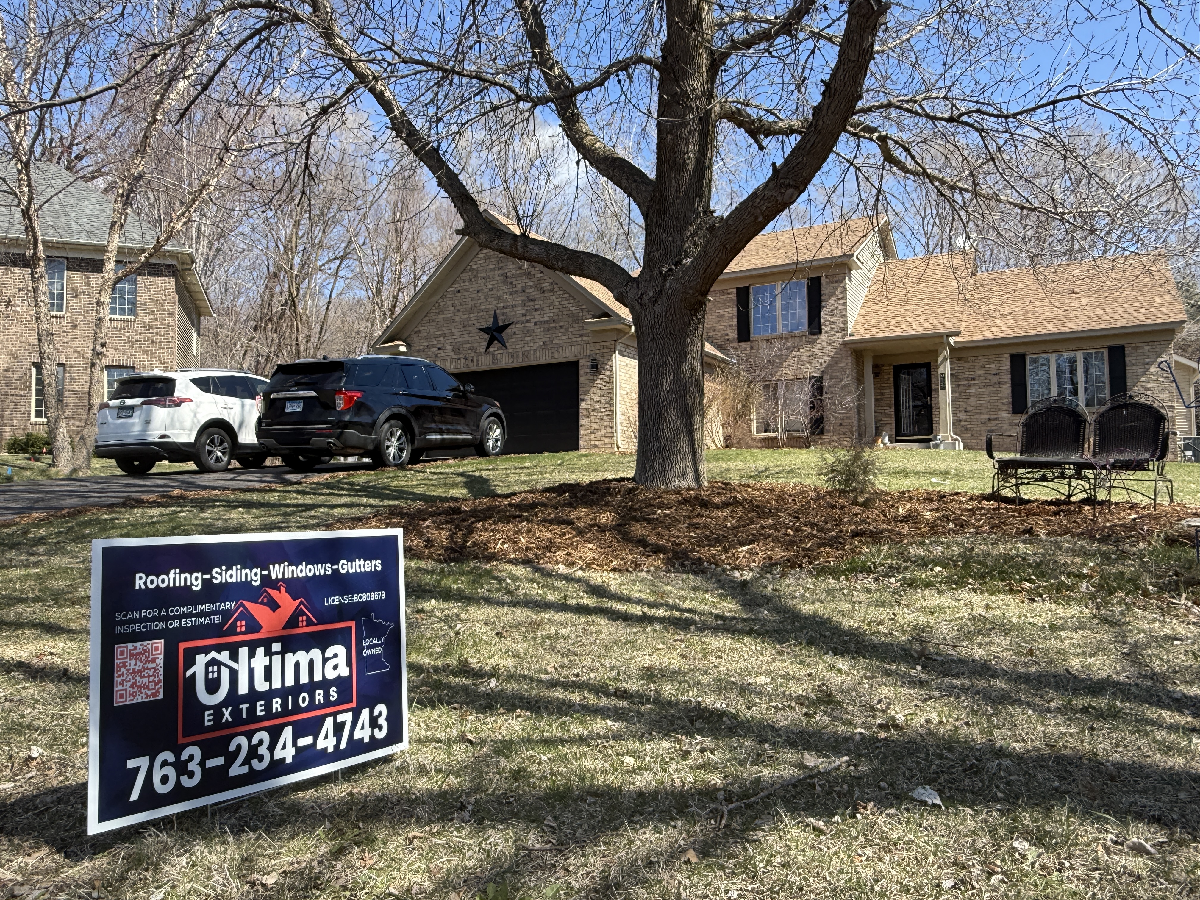 Ultima Exteriors yard sign in front of a home